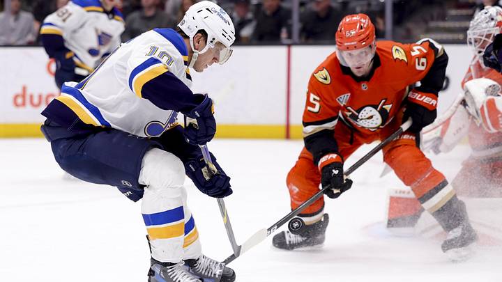 Mar 7, 2025; Anaheim, California, USA; St. Louis Blues center Brayden Schenn (10) shoots against Anaheim Ducks defenseman Jacob Trouba (65) during the third period at Honda Center. Mandatory Credit: Ryan Sun-Imagn Images