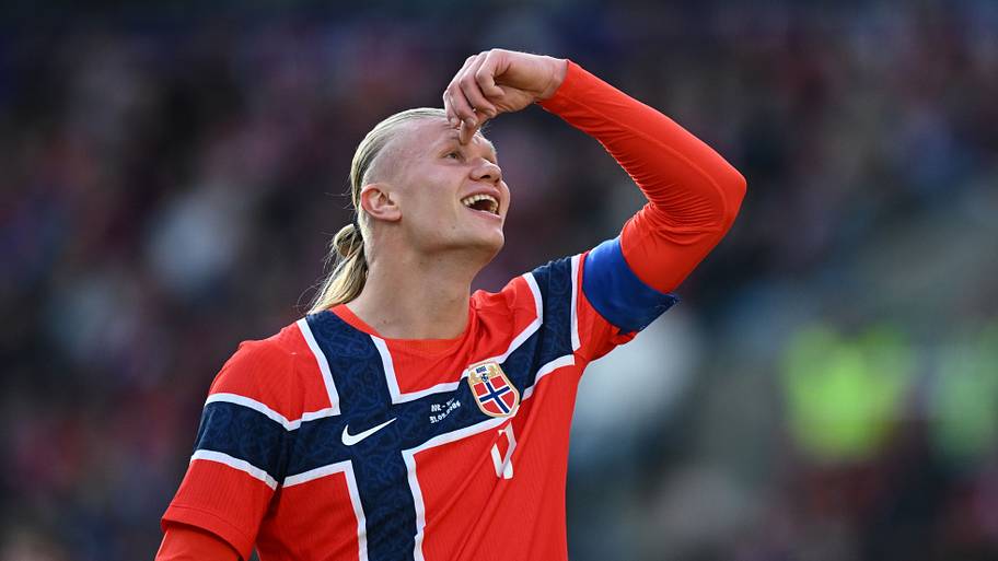 Erling Haaland laughs and looks to the sky while in action for Norway. 