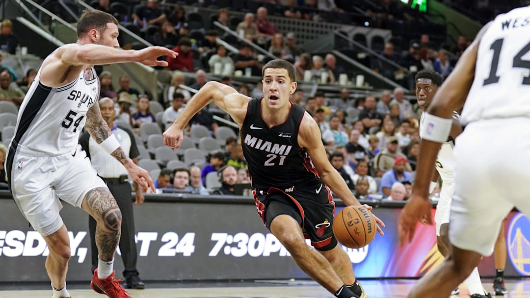Oct 13, 2023; San Antonio, Texas, USA; Miami Heat forward Cole Swider (21) drives to the basket against San Antonio Spurs forward Sandro Mamukelashvili (54) during the second half at Frost Bank Center. Mandatory Credit: Scott Wachter-Imagn Images