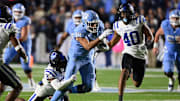 Nov 11, 2023; Chapel Hill, North Carolina, USA; North Carolina Tar Heels tight end Bryson Nesbit (18) catches the ball as Duke Blue Devils safety Jaylen Stinson (2) defends to set up a field goal attempt at the end of the fourth quarter at Kenan Memorial Stadium. 