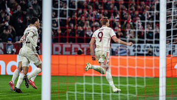 Harry Kane celebrating after scoring for Bayern Munich against Bayer Leverkusen.