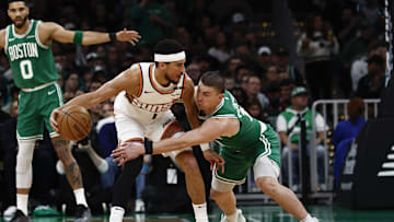 Apr 4, 2025; Boston, Massachusetts, USA; Boston Celtics guard Payton Pritchard (11) tries to knock the ball away from Phoenix Suns guard Devin Booker (1) during the first quarter at TD Garden. Mandatory Credit: Winslow Townson-Imagn Images