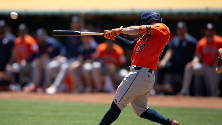 Houston Astros second baseman Jose Altuve (27) hits an RBI single against the Oakland Athletics during the second inning at Oakland-Alameda County Coliseum on July 24.