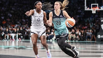 Jul 8, 2025; Brooklyn, New York;  New York Liberty guard Sabrina Ionescu (20) drives past Las Vegas Aces guard Jackie Young (0) in the third quarter at Barclays Center. 