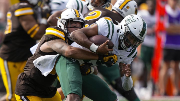 Sep 9, 2023; Laramie, Wyoming, USA; Wyoming Cowboys linebacker Shae Suiaunoa (43) sacks Portland State Vikings quarterback Dante Chachere (15) during the third quarter at Jonah Field at War Memorial Stadium. Mandatory Credit: Troy Babbitt-USA TODAY Sports