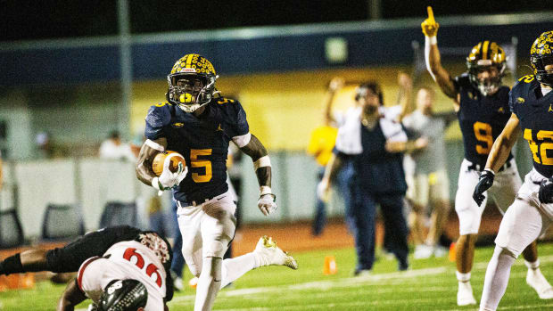 Naples running back Shawn Simeon scored four times in a win over Barron Collier on Aug. 30, 2004.