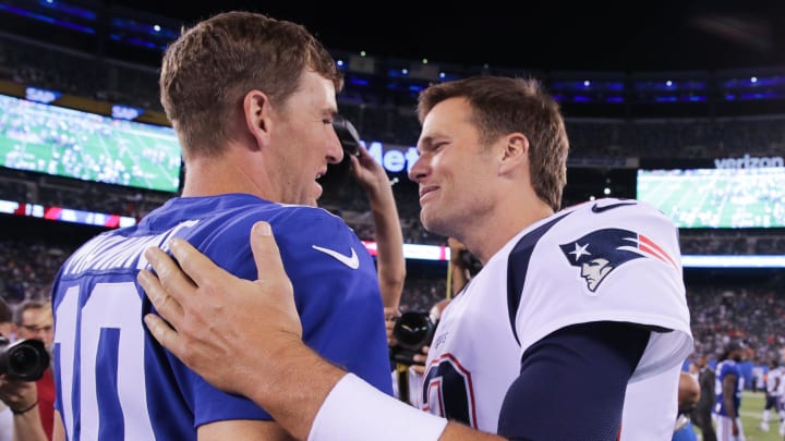 Aug 30, 2018; East Rutherford, NJ, USA; New York Giants quarterback Eli Manning (10) shakes hands with New England Patriots quarterback Tom Brady (12) after their game at MetLife Stadium. Mandatory Credit: Vincent Carchietta-USA TODAY Sports