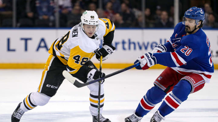 Apr 1, 2024; New York, New York, USA; Pittsburgh Penguins right wing Valtteri Puustinen (48) tries to skate by New York Rangers left wing Chris Kreider (20) during the first period at Madison Square Garden.