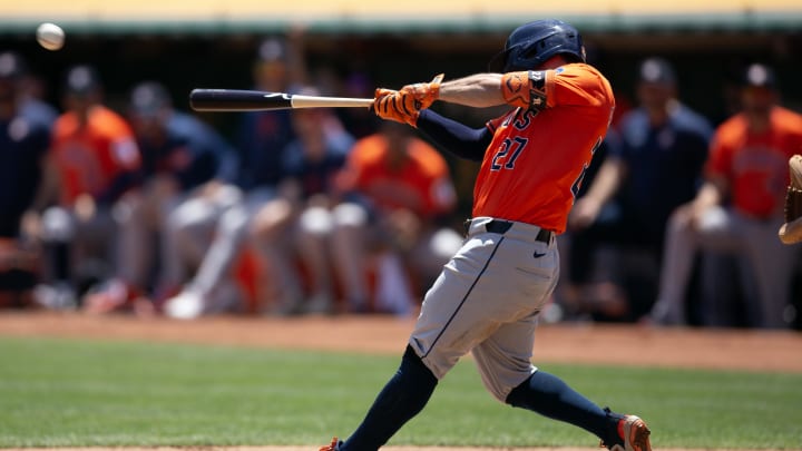 Jul 24, 2024; Oakland, California, USA; Houston Astros second baseman Jose Altuve (27) hits an RBI single against the Oakland Athletics during the second inning at Oakland-Alameda County Coliseum. 