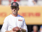 Shanahan watches warm ups before the game against the New Orleans Saints at Levi's Stadium.