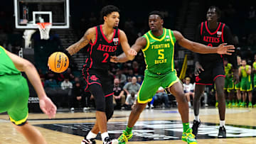 Nov 27, 2024; Las Vegas, Nevada, USA; San Diego State Aztecs guard Nick Boyd (2) dribbles against Oregon Ducks guard TJ Bamba (5) during the second half at MGM Grand Garden Arena. Mandatory Credit: Stephen R. Sylvanie-Imagn Images