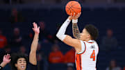 Nov 18, 2025; Syracuse, New York, USA; Syracuse Orange guard Nate Kingz (4) shoots against Monmouth Hawks guard Justin Ray (left) during the first half at the JMA Wireless Dome. Mandatory Credit: Rich Barnes-Imagn Images