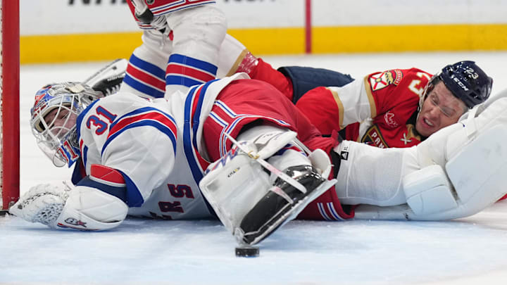 Dec 30, 2024; Sunrise, Florida, USA; New York Rangers goaltender Igor Shesterkin (31) loses possession of the puck as Florida Panthers center Carter Verhaeghe (23) falls on top of him during the second period at Amerant Bank Arena. Mandatory Credit: Jim Rassol-Imagn Images Dec 30, 2024; Sunrise, Florida, USA; New York Rangers goaltender Igor Shesterkin (31) loses possession of the puck as Florida Panthers center Carter Verhaeghe (23) falls on top of him during the second period at Amerant Bank Arena. Mandatory Credit: Jim Rassol-Imagn Images