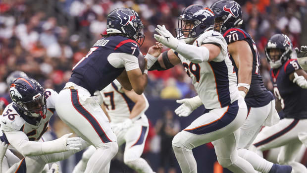 Denver Broncos defensive end Zach Allen (99) attempts to tackle Houston Texans quarterback C.J. Stroud (7).