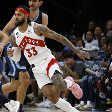 Feb 5, 2023; Memphis, Tennessee, USA; Memphis Grizzlies guard Tyus Jones (21) dribbles as Toronto Raptors guard Gary Trent Jr. (33) defends during the first half at FedExForum. Mandatory Credit: Petre Thomas-USA TODAY Sports