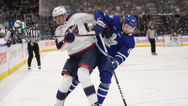 Dec 14, 2023; Toronto, Ontario, CAN; Columbus Blue Jackets forward Patrik Laine (29) and Toronto Maple Leafs defenseman William Lagesson (85) battle for position during the second period at Scotiabank Arena. Mandatory Credit: John E. Sokolowski-USA TODAY Sports