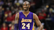 The late, great Los Angeles Lakers forward Kobe Bryant smiles during a game against the Houston Rockets on Dec. 12, 2015.