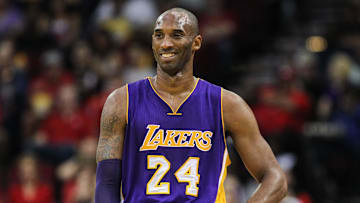 The late, great Los Angeles Lakers forward Kobe Bryant smiles during a game against the Houston Rockets on Dec. 12, 2015.