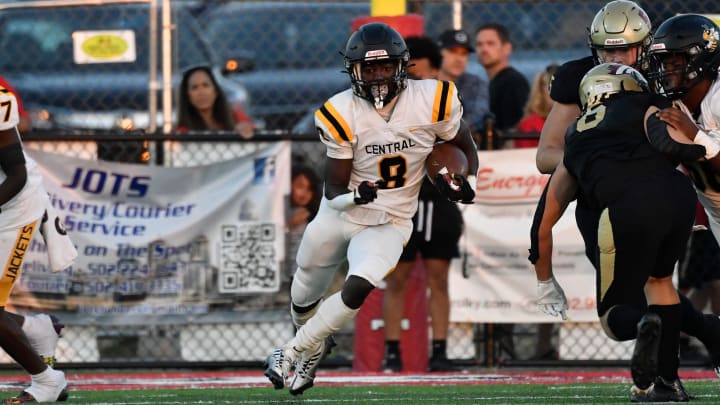 Central's Cortez Stone (8) runs through an opening in the Bullitt East line during the first half of their game, Friday, Sept. 15 2023 in Mount Washington Ky.