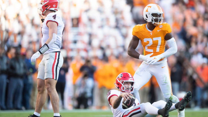 Georgia quarterback Carson Beck (15) is seen on the ground in front of Tennessee defensive lineman James Pearce Jr. (27) during a football game between Tennessee and Georgia at Neyland Stadium in Knoxville, Tenn., on Saturday, Nov. 18, 2023.