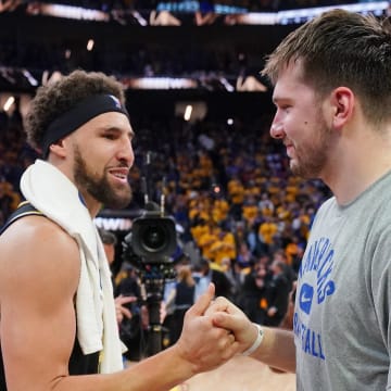 May 26, 2022; San Francisco, California, USA; Dallas Mavericks guard Luka Doncic (77) with Golden State Warriors guard Klay Thompson (11) after game five of the 2022 western conference finals against the Dallas Mavericks at Chase Center. Mandatory Credit: Cary Edmondson-USA TODAY Sports