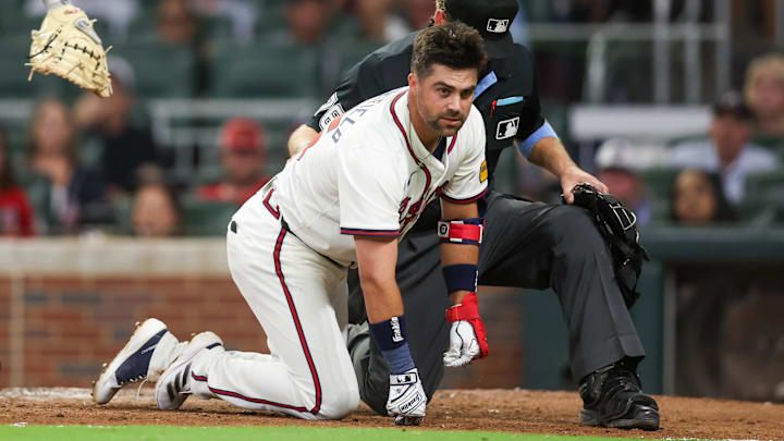 Atlanta Braves infielder Whit Merrifield lands on the ground after getting hit in the head by a pitch during Tuesday's victory over the Colorado Rockies. 