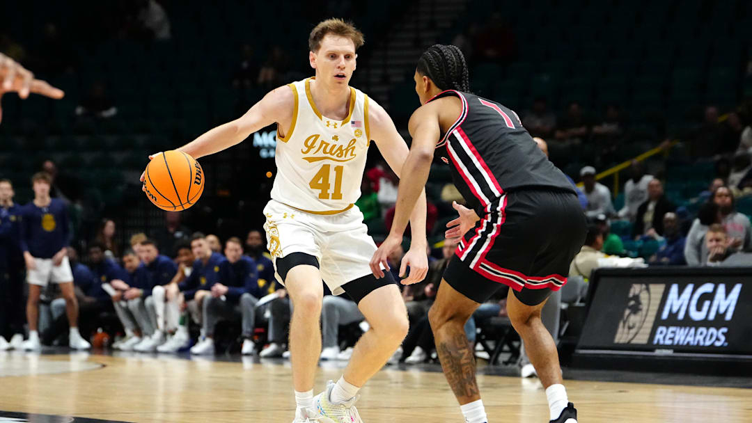 Nov 27, 2024; Las Vegas, Nevada, USA; Notre Dame Fighting Irish guard Matt Allocco (41) dribbles against Houston Cougars guard Milos Uzan (7) during the first half at MGM Grand Garden Arena. Mandatory Credit: Stephen R. Sylvanie-Imagn Images