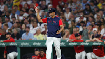 Jul 2, 2025; Boston, Massachusetts, USA; Boston Red Sox manager Alex Cora (13) makes a pitching change during the seventh inning against the Cincinnati Reds at Fenway Park. Mandatory Credit: Paul Rutherford-Imagn Images