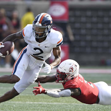 Oct 9, 2021; Louisville, Kentucky, USA;  Virginia Cavaliers wide receiver Ra'Shaun Henry (2) avoids the tackle of Louisville Cardinals defensive back Chandler Jones (2) during the second quarter at Cardinal Stadium. Mandatory Credit: Jamie Rhodes-Imagn Images