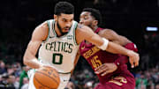 Dec 12, 2023; Boston, Massachusetts, USA; Boston Celtics forward Jayson Tatum (0) drives the ball against Cleveland Cavaliers guard Donovan Mitchell (45) in the second half at TD Garden. Mandatory Credit: David Butler II-Imagn Images