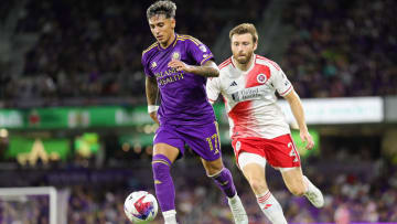 Oct 7, 2023; Orlando, Florida, USA;  Orlando City SC forward Facundo Torres (17) and New England Revolution defender Dave Romney (2) battle for the ball in the second half at Exploria Stadium. Mandatory Credit: Nathan Ray Seebeck-USA TODAY Sports