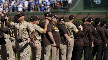 San Diego Padres manager Mike Shildt (left) is introduced before Game 1 of the National League Wild Card series at Wrigley Field on Sept. 30. Victor Rodriguez is at center.