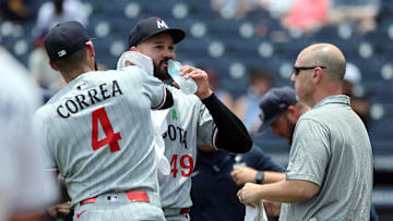May 28, 2025; Minneapolis, Minnesota, USA; Minnesota Twins shortstop Carlos Correa (4) wipes down starting pitcher Pablo Lopez (49) as he takes a sip of water as the grounds crew fix the mound during the first inning against the Tampa Bay Rays at George M. Steinbrenner Field. Mandatory Credit: Kim Klement Neitzel-Imagn Images
