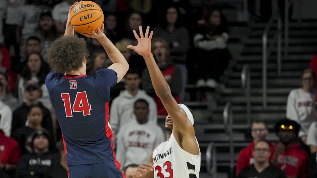 Former Detroit Mercy Titans guard Jayden Stone (14) rises for a shot over a defender, in a game against the Cincinnati Bearcats two seasons ago.