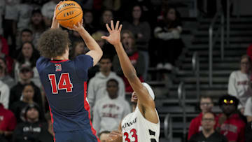 Former Detroit Mercy Titans guard Jayden Stone (14) rises for a shot over a defender, in a game against the Cincinnati Bearcats two seasons ago.