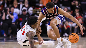 Jan 4, 2025; Cincinnati, Ohio, USA; Cincinnati Bearcats forward Dillon Mitchell (23) battles for the ball against Arizona Wildcats forward Carter Bryant (9) in the second half at Fifth Third Arena. Mandatory Credit: Katie Stratman-Imagn Images