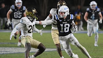 Nov 29, 2025; Durham, North Carolina, USA; Duke Blue Devils wide receiver Cooper Barkate (18) runs the ball against Wake Forest Demon Deacons defensive back Lardarius Webb Jr. (20) during the fourth quarter at Wallace Wade Stadium. Mandatory Credit: Zachary Taft-Imagn Images