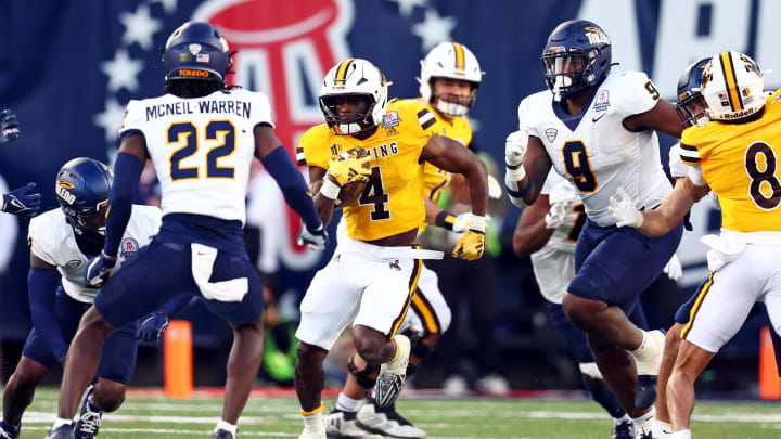 Dec 30, 2023; Tucson, AZ, USA; Wyoming Cowboys running back Harrison Waylee (4) runs the ball against the Toledo Rockets.