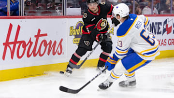 Sep 26, 2024; Ottawa, Ontario, CAN; Ottawa Senators defenseman Calen Addison (6) moves the puck past Buffalo Sabres right wing Isak Rosen (63) in the second period at the Canadian Tire Centre. Mandatory Credit: Marc DesRosiers-Imagn Images