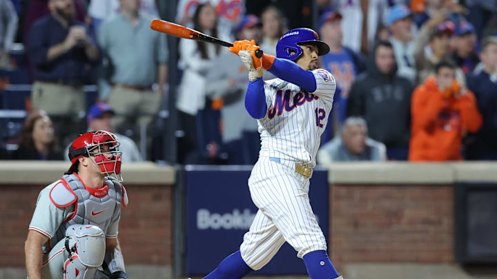 Oct 9, 2024; New York, New York, USA; New York Mets shortstop Francisco Lindor (12) hits a grand slam against the Philadelphia Phillies in the sixth inning in game four of the NLDS for the 2024 MLB Playoffs at Citi Field. Mandatory Credit: Brad Penner-Imagn Images