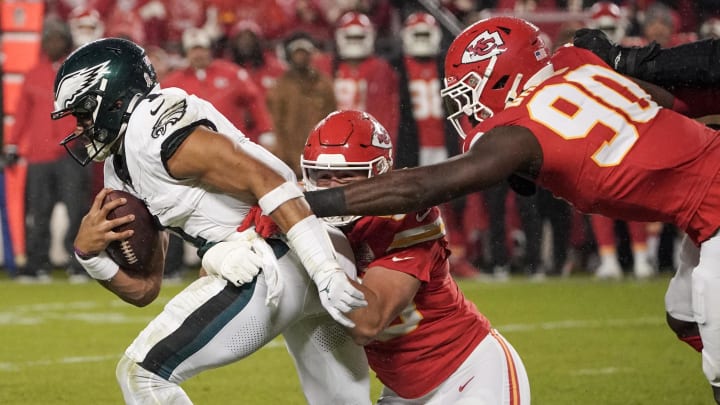 Nov 20, 2023; Kansas City, Missouri, USA; Philadelphia Eagles quarterback Jalen Hurts (1) is sacked by Kansas City Chiefs defensive end Charles Omenihu (90) and defensive end George Karlaftis (56) during the first half at GEHA Field at Arrowhead Stadium. Mandatory Credit: Denny Medley-USA TODAY Sports