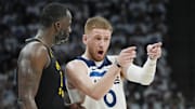 May 6, 2025; Minneapolis, Minnesota, USA; Minnesota Timberwolves guard Donte DiVincenzo (0) reacts with Golden State Warriors forward Draymond Green (23) in the third quarter during game one of the second round for the 2025 NBA Playoffs at Target Center. Mandatory Credit: Bruce Kluckhohn-Imagn Images