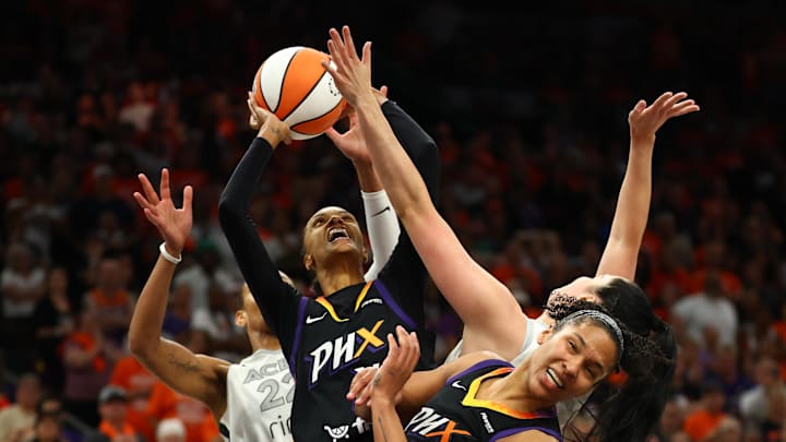Oct 8, 2025; Phoenix, Arizona, USA; Phoenix Mercury forward DeWanna Bonner (14) shoots the ball over Las Vegas Aces center A'ja Wilson (22) in the second half during game three of the 2025 WNBA Finals at PHX Arena. Mandatory Credit: Mark J. Rebilas-Imagn Images Oct 8, 2025; Phoenix, Arizona, USA; Phoenix Mercury forward DeWanna Bonner (14) shoots the ball over Las Vegas Aces center A'ja Wilson (22) in the second half during game three of the 2025 WNBA Finals at PHX Arena. Mandatory Credit: Mark J. Rebilas-Imagn Images