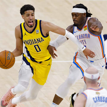 Jun 16, 2025; Oklahoma City, Oklahoma, USA; Indiana Pacers guard Tyrese Haliburton (0) drives to the basket past Oklahoma City Thunder guard Luguentz Dort (5) during the third quarter in game five of the 2025 NBA Finals at Paycom Center. Mandatory Credit: Alonzo Adams-Imagn Images