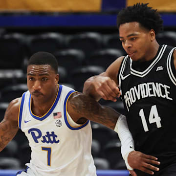 Oct 19, 2025; Pittsburgh, PA, USA;  Pittsburgh Panthers guard Damarco Minor (7) controls the ball against Providence Friars guard Corey Floyd Jr. (14) during the second half at the Petersen Events Center. Mandatory Credit: Charles LeClaire-Imagn Images
