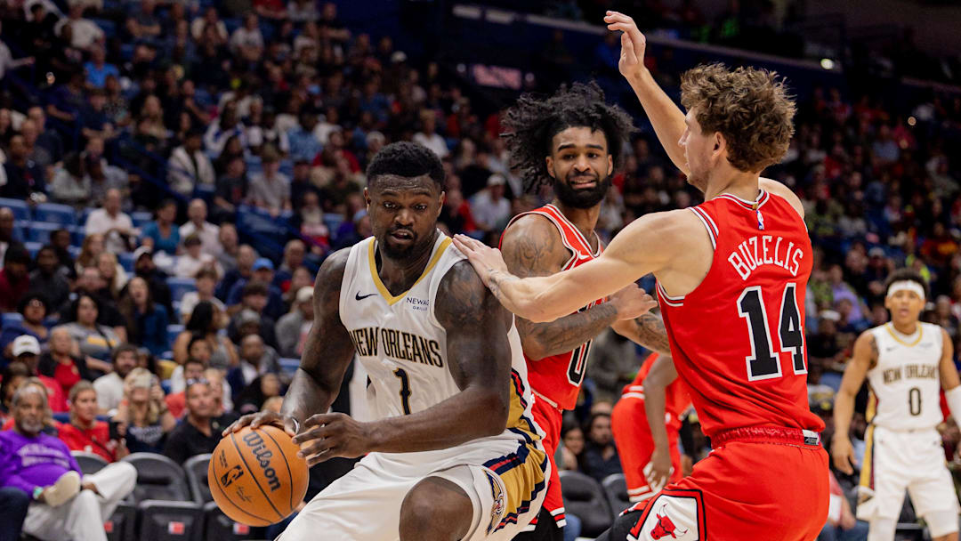 Nov 24, 2025; New Orleans, Louisiana, USA;  New Orleans Pelicans forward Zion Williamson (1) dribbles against Chicago Bulls forward Matas Buzelis (14) during the first half at Smoothie King Center. Mandatory Credit: Stephen Lew-Imagn Images