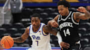 Oct 19, 2025; Pittsburgh, PA, USA;  Pittsburgh Panthers guard Damarco Minor (7) controls the ball against Providence Friars guard Corey Floyd Jr. (14) during the second half at the Petersen Events Center. Mandatory Credit: Charles LeClaire-Imagn Images