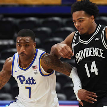 Oct 19, 2025; Pittsburgh, PA, USA;  Pittsburgh Panthers guard Damarco Minor (7) controls the ball against Providence Friars guard Corey Floyd Jr. (14) during the second half at the Petersen Events Center. Mandatory Credit: Charles LeClaire-Imagn Images