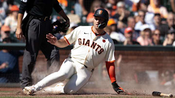 Sep 29, 2024; San Francisco, California, USA; San Francisco Giants third baseman Casey Schmitt (10) slides home during the seventh inning against the St. Louis Cardinals at Oracle Park. 