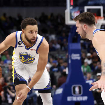 Nov 29, 2022; Dallas, Texas, USA;  Golden State Warriors guard Stephen Curry (30) dribbles as Dallas Mavericks guard Luka Doncic (77) defends during the first quarter at American Airlines Center. Mandatory Credit: Kevin Jairaj-USA TODAY Sports